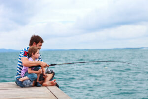 Father,And,His,Little,Son,Fishing,Together,From,Wooden,Jetty